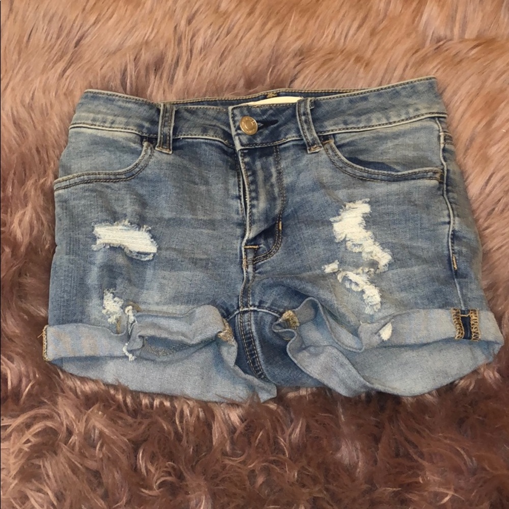 Ripped mid wash denim jean shorts.